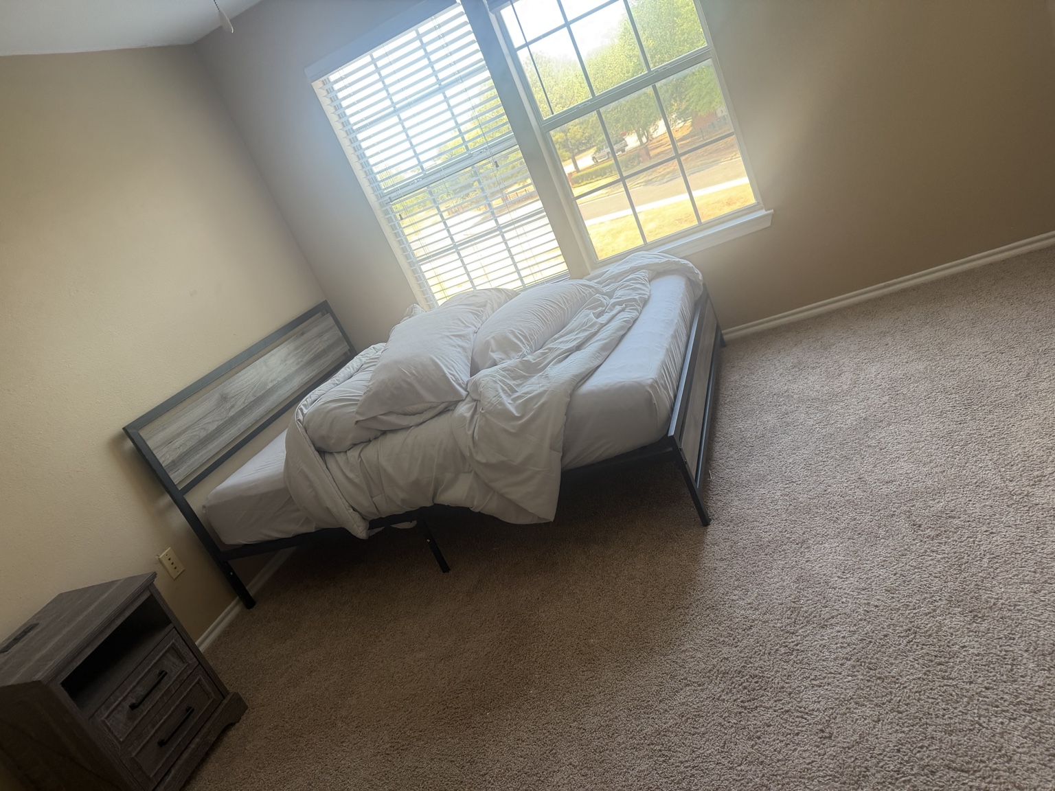 Bed frame assembled in a completed bedroom