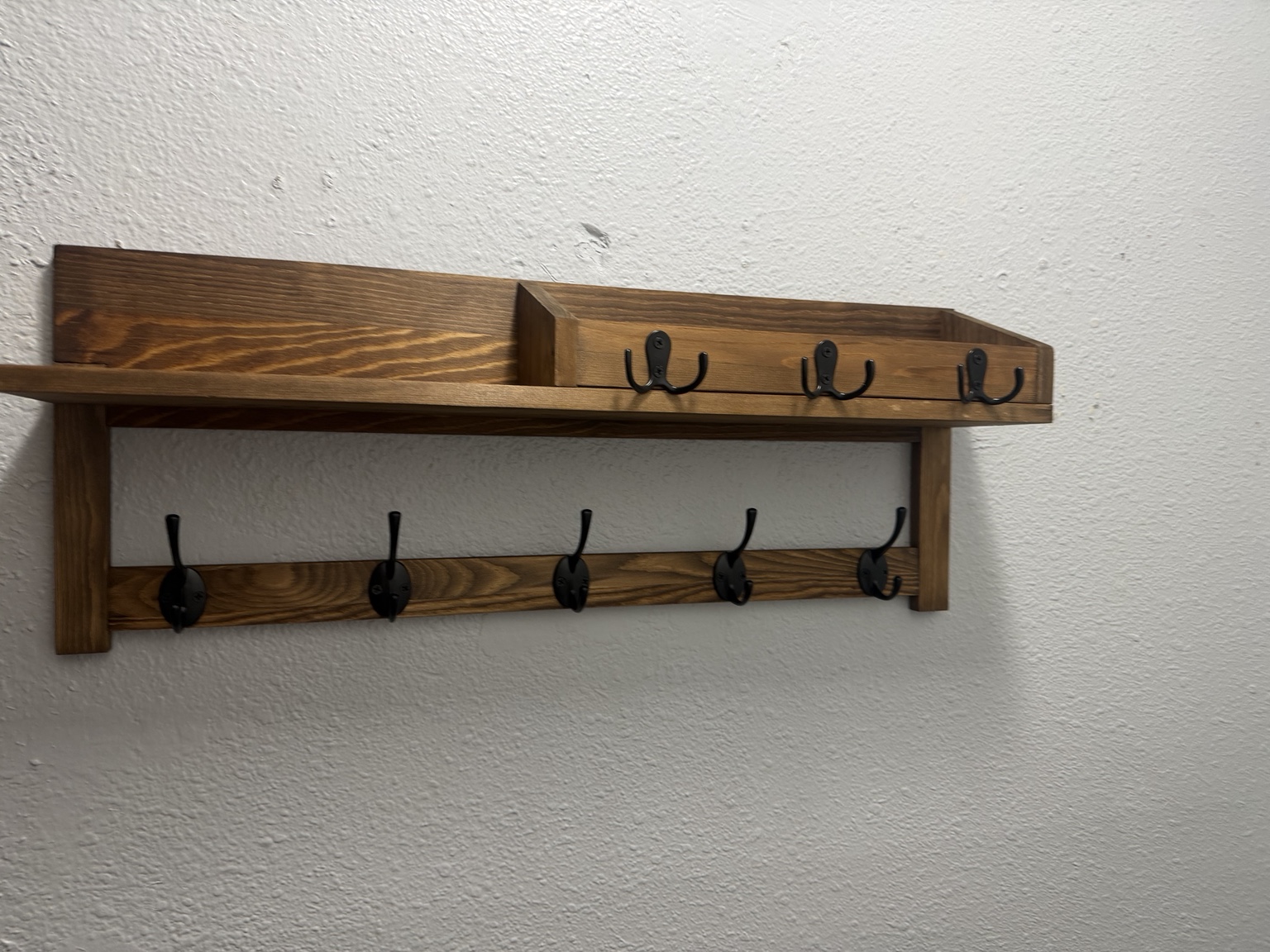 Wooden wall-mounted coat rack installed