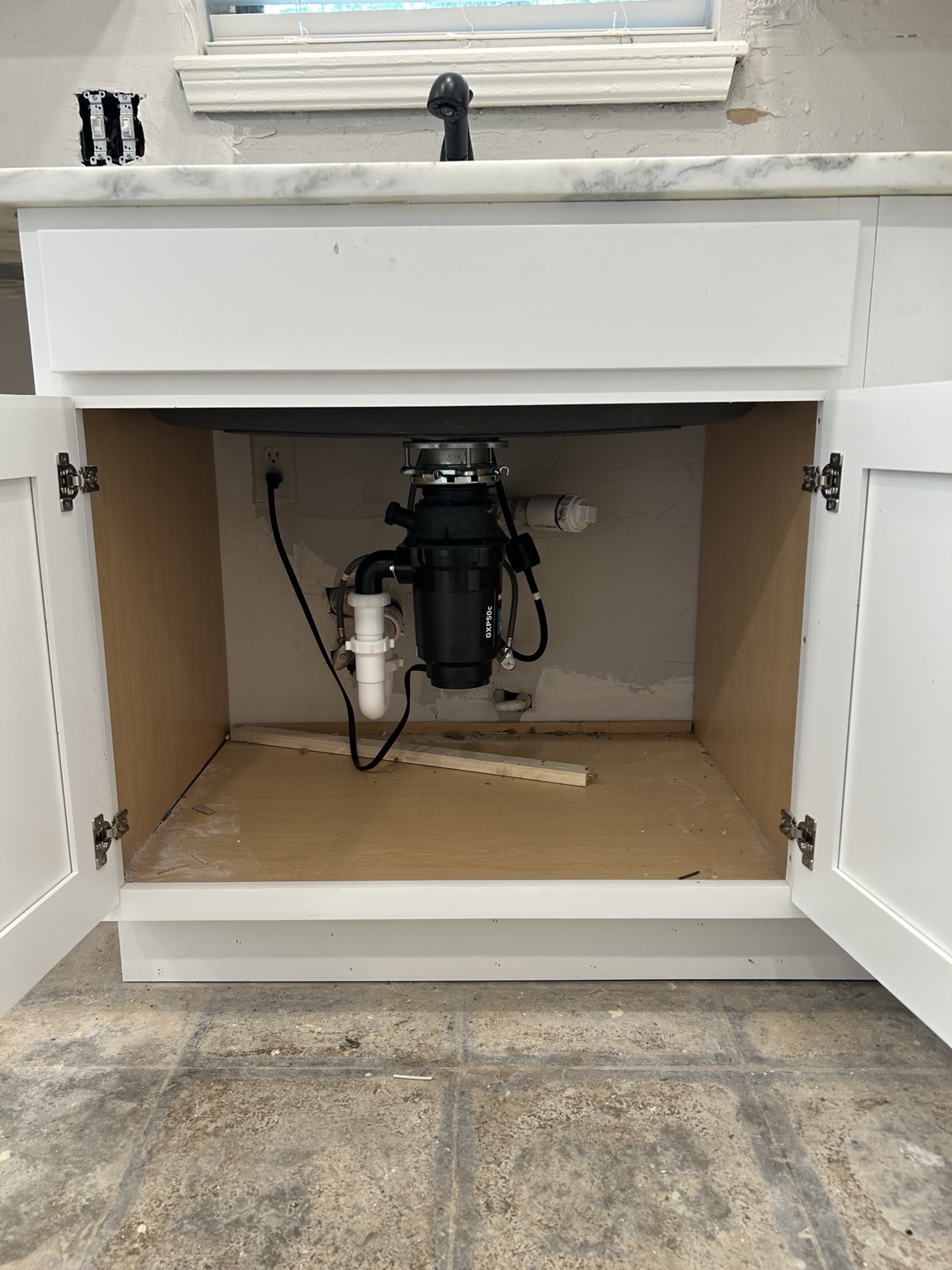 Garbage disposal installed beneath a kitchen sink