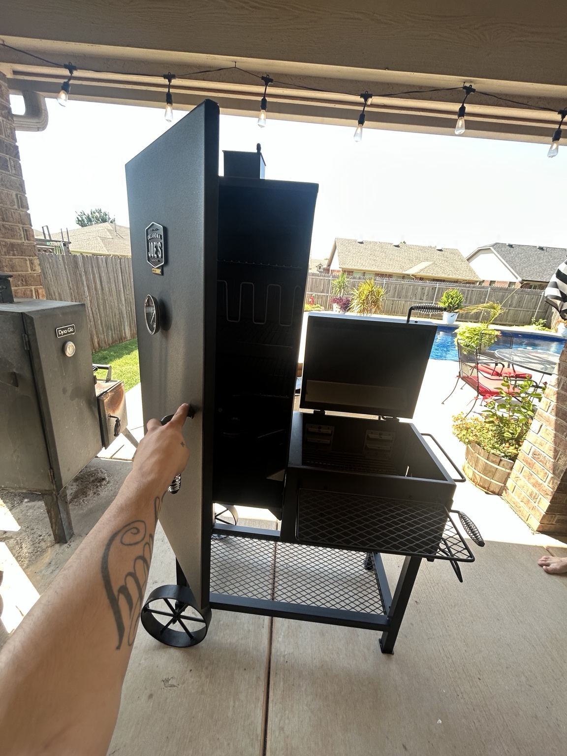 Outdoor smoker grill assembled on a patio