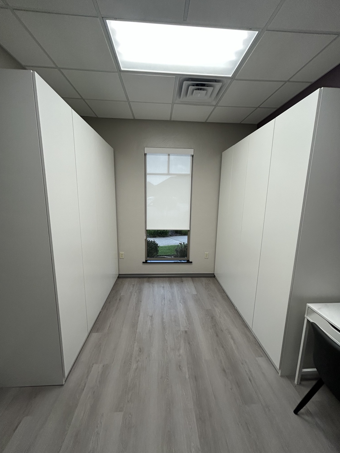 Completed office storage wall with cabinets and shelving