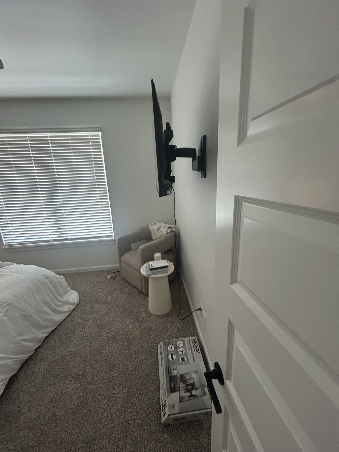 Television mounted on an adjustable wall bracket